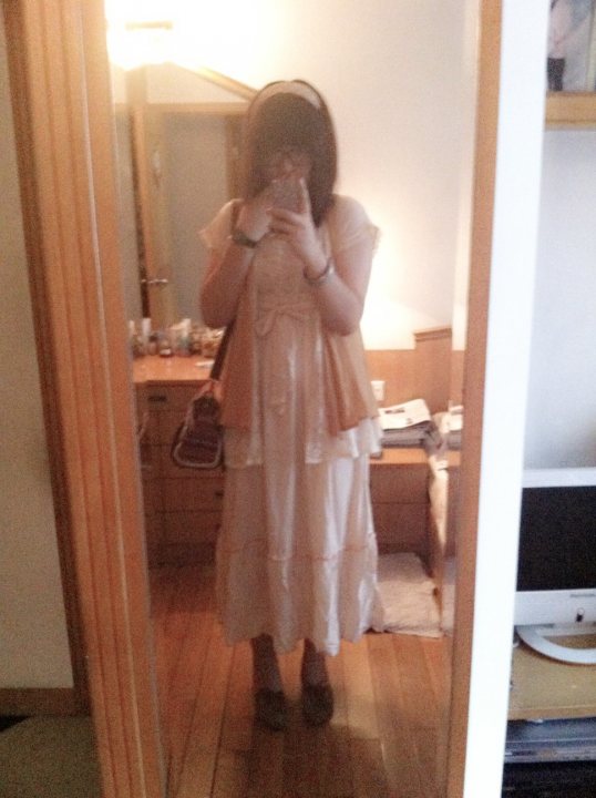 A woman standing in front of a mirror in a bathroom