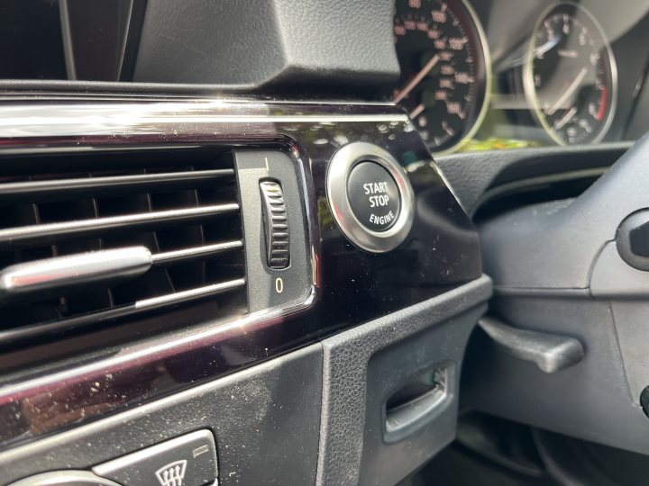 Pistonheads - The image shows a close-up of the interior of a car, focusing on the center console. There's an automatic transmission lever in the foreground, indicating it's a manual shift vehicle. Behind the gear shift, you can see the dashboard with various controls and gauges visible. The steering wheel is also partially visible at the bottom left corner of the image, indicating that the car is being viewed from inside the vehicle.