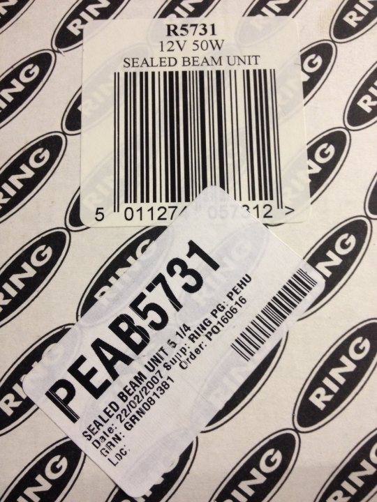 2.5 headlights what are they off ? - Page 1 - Noble - PistonHeads - The image shows an open pack of Peabody Beam Unit, specifically the R5731 model, which is intended for 12 volt operation. The item is bathed in light, indicating it might be a unique find given how rare it is. The United States Department of Energy is responsible for the certification and quality of the product, as indicated by the label. The product is not in use but has been stored, as evidenced by the use of C-rings from 2007 to 2009.