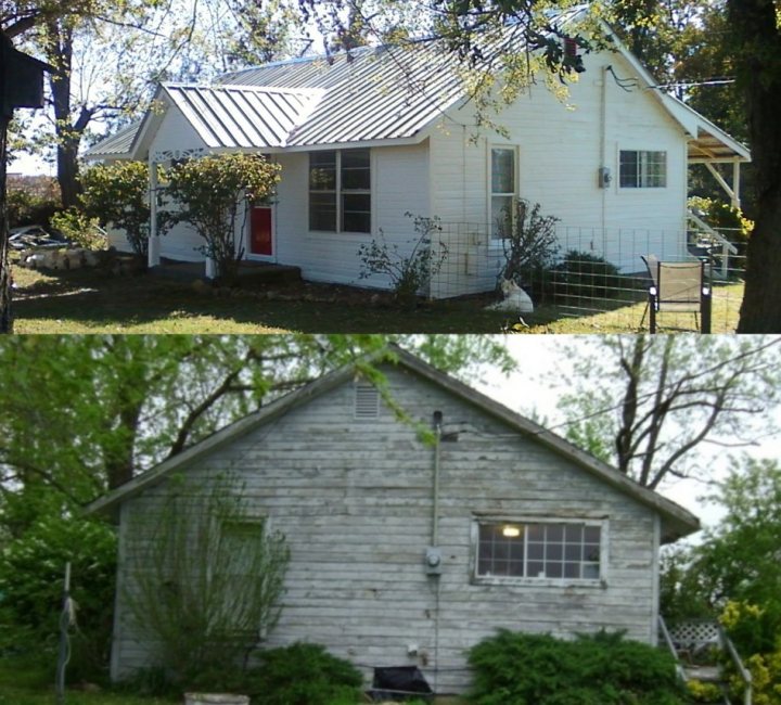 The image is a composite of two separate photographs of a house. The larger photo showcases the front of a house, featuring two visible windows, a white door, a gutter system, and a concrete path leading up to the entrance. The house is wrapped with horizontal siding that's painted a shade of white. A few bushes and shrubs enhance the greenery surrounding the house. The smaller photo on the right offers a similar view of the same house, albeit with variations in focus and lighting. This merge image is meant to illustrate the house's facade and conditions between the two pictures, emphasizing the state before renovation and the renovated state after home improvements.