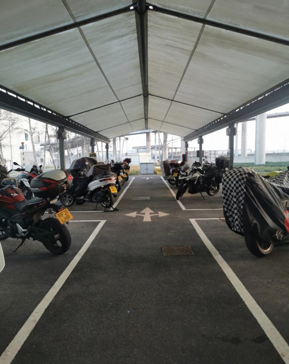 A group of motorcycles parked in front of a building - Pistonheads