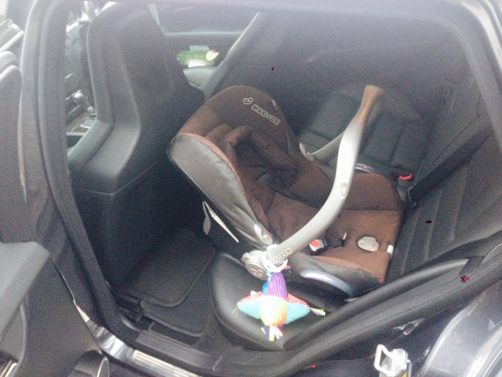 A close up of a motorcycle in a car - Pistonheads - The image captures the interior of a car that has been recently cleaned. The focus is on the back seat, which is where the main subject is located: a large child seat that has been dismantled and taken out of its usual position. This suggests that the car is being prepared for a move, or the family has decided to sell it.