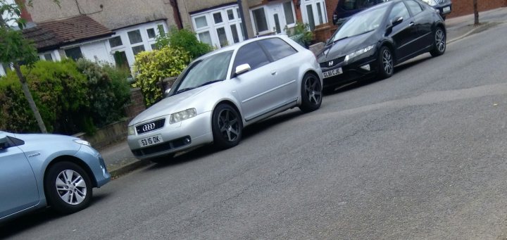 What C124PPY personalised plates have you seen recently? - Page 480 - General Gassing - PistonHeads - The image captures a peaceful suburban scene. A gray car is parked by the side of a quiet street, adding to the calm ambiance of the neighborhood. The street itself appears well-maintained, with no visible signs of disarray or neglect. A few other cars are also present, parked along the street, suggesting that this might be a residential area where families live. On the left side of the photo, there's an empty sidewalk, leading to what seems to be a house in the background. The overall impression is one of tranquility and orderliness.