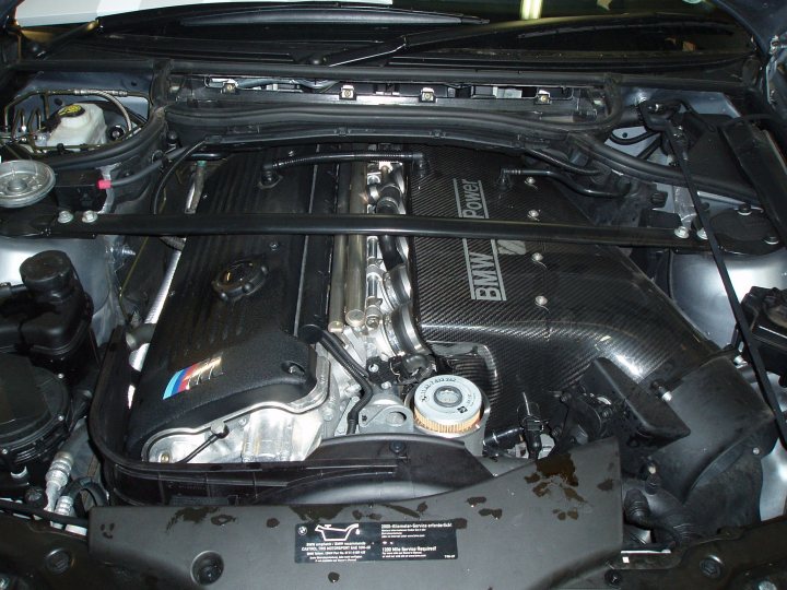 Which BMW dealer for servicing a CSL? - Page 1 - CSL - PistonHeads - This image shows the underside of a car engine, featuring its mechanical components. The engine compartment is open, and the car's hood is up, exposing the engine. At the bottom center, there is a black weather strip, possibly part of the car door seal. The engine components visible in the picture include a cooling system, a metal casing, and some wiring. There are also markings and symbols on the engine cover.