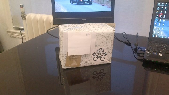 A flat screen tv sitting on top of a table - Pistonheads