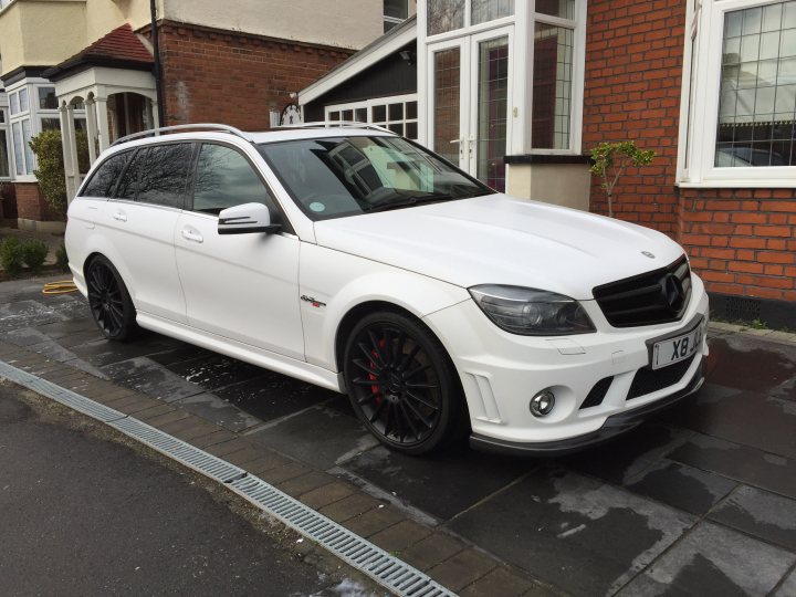 Show us your Mercedes! - Page 57 - Mercedes - PistonHeads - The image shows a white Mercedes-Benz car parked on a driveway. The vehicle appears to be a modern SUV model, possibly of the M Class generation. The car has drawn alloy wheels and a shiny exterior finish. It is parked in front of a brick house with a front garden that includes a small tree next to the entrance. There are no visible people or other vehicles in the frame. The scene suggests a suburban residential setting.