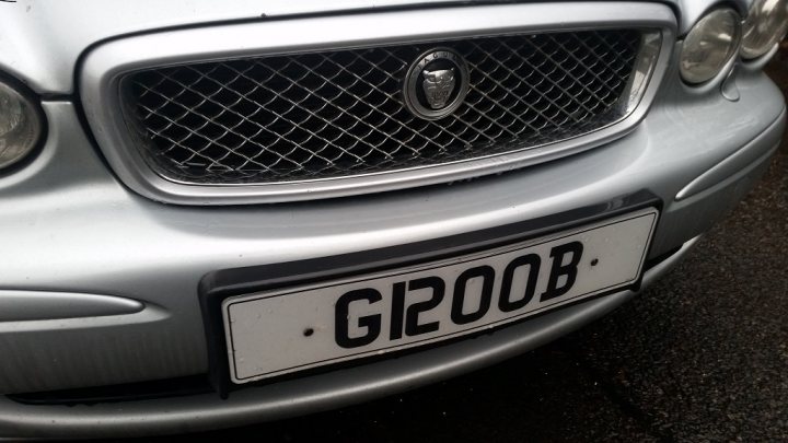 What C124PPY personalised plates have you seen recently? - Page 183 - General Gassing - PistonHeads - The image shows the front of a silver car. The car is adorned with a large silver grille and is prominently displayed on a black background. A white license plate is attached to the front of the vehicle, with the letters and numbers "GI200B" printed on it. The car's sleek design and shiny finish suggest it's well-maintained. The background is simple and dark, placing the focus on the car.