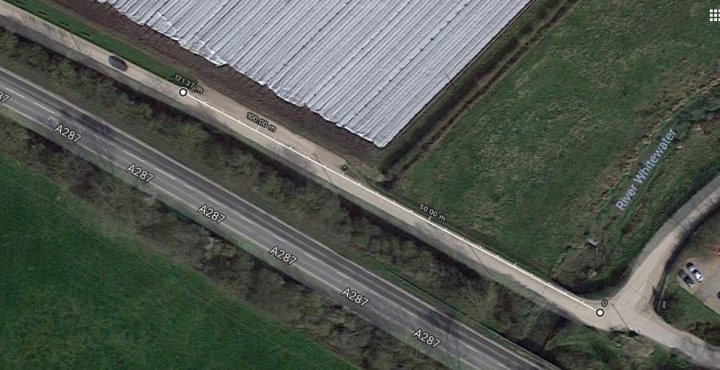 13yr old killed in F50 - Page 52 - News, Politics & Economics - PistonHeads - The image presents an aerial view of a multi-lane road. There are a number of cars visible on the highway, suggesting traffic flow. On the other side of the road, there is an airport runway. The runway is bordered by a field. There is an area with buildings located near the runway.