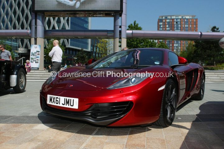 A red motorcycle is parked in a parking lot - Pistonheads - 