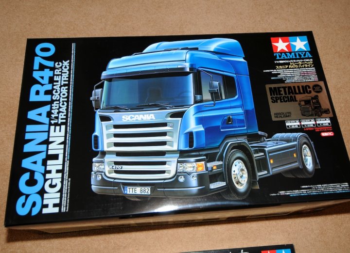 Tamiya Scania R470 Build Pictures - Page 1 - Scale Models - PistonHeads - The image showcases a box for a model truck, the Scania R400. The truck model is the Tadra model track. The box is predominantly black with colorful graphics. It's a clear representation of a toy truck and is designed for easy removal of the truck. The text on the box is in a mix of English and Chinese, indicating that the model truck is a special edition, possibly limited edition.