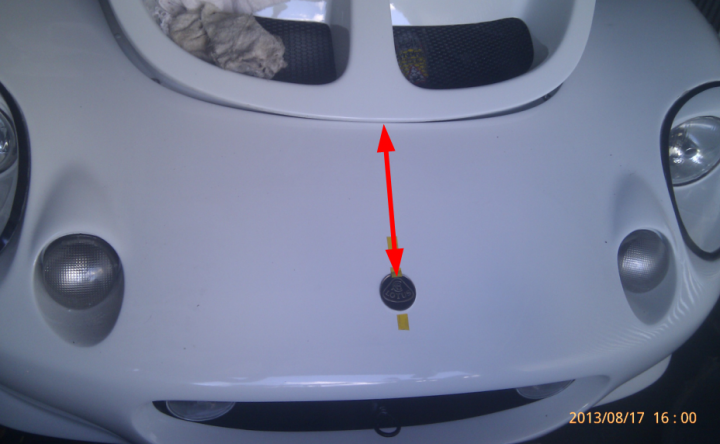 A large white cake sitting on top of a table - Pistonheads - The image captures a close-up view of a white Ferrari car, emphasizing the hood area. A red arrow points towards a yellow square, presumably indicating some sort of repair or maintenance work requiring attention. The car's headlights are also visible, adding depth and context to the photograph. There's a seat, possibly from a golf cart, propped open in the background, creating a contrasting element to the high-end car. The date and time stamp on the image confirm it was taken on August 17th, 2013, at 5:21 PM.