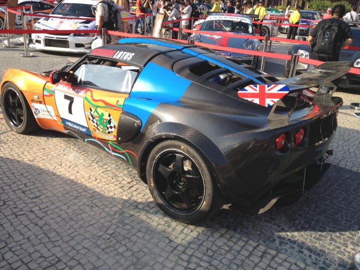 Pistonheads - The image shows a striking blue and black race car parked on a cobblestone street or perhaps a track. The car features a prominent British flag on its rear wing, but it's not just any race car; it's a Stig-inspired ride, suggesting it might be a part of the well-known Top Gear television show. There are people around the car, possibly attendees of a car event or fans of the show that are showing off their interest in cars. The car's sleek design and vibrant colors reliably draw attention, making it a focal point of the picture.