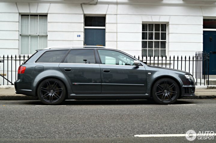 So what car have you been obsessing about today?? (Vol 2) - Page 411 - General Gassing - PistonHeads - The image shows a gray car parked on the side of a city street. The car is positioned along the curb, between two buildings which feature white facades and dark balconies, and there are black metal barriers or railings in front and behind the vehicle. The street appears to be calm and quite, with no visible pedestrians or moving traffic.