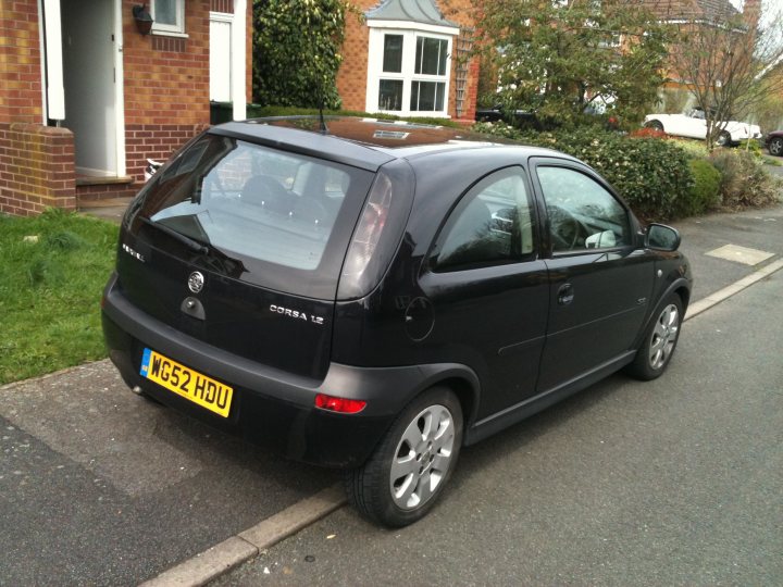 Pistonheads - The image presents a dark-colored hatchback car parked on a residential street. The car's license plate indicates that it's registered in the United Kingdom, with "HG52" as the registration marker. The car features a distinctive round badge on the hatchback, suggesting it's likely a European model. The setting is a calm neighborhood street, lined with neatly trimmed hedges and sporting an occasional flow of traffic on the right side of the image, hinting at life's hustle and bustle even in tranquil settings.