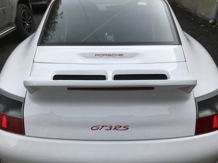 A white car parked in a parking lot - Pistonheads