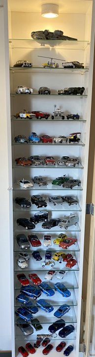 A display case filled with lots of different colored vases - Pistonheads