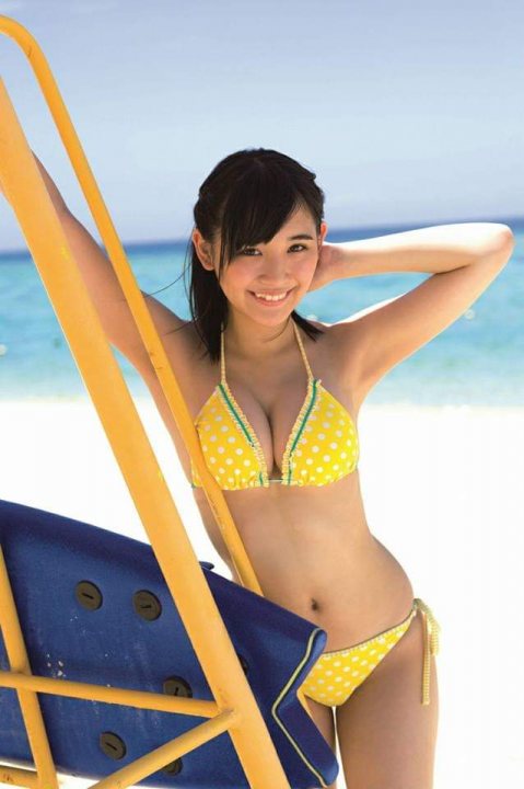 A woman in a bikini holding a surfboard