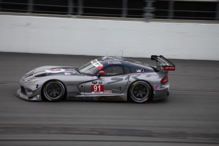 A car is parked on the side of the road - Pistonheads - The image captures the intense action of a high-performance race car in motion on a race track. The car, which appears to be a Porsche, is adorned with a prominent number "91" on its side and the license plate number "M40" at the rear. Its stance is hugging the inside of the turn on the track, demonstrating the expert handling required for such high-speed racing. The background features a blurred image of a clear sky and a fence, emphasizing the vehicle's high speed.