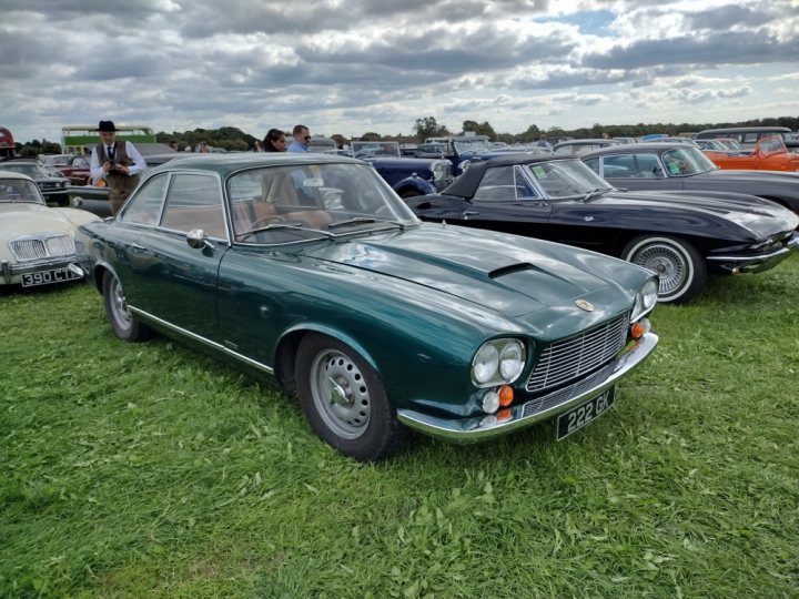 A vintage car is parked in a field - Pistonheads