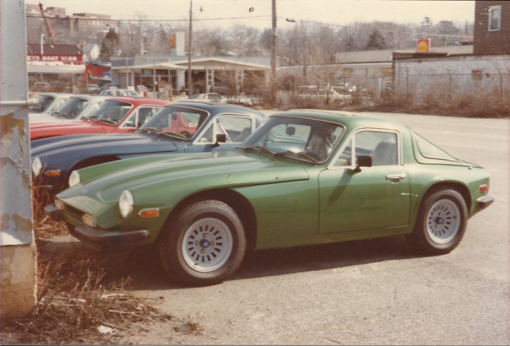 Last 3000S exports to US? - Page 1 - Classics - PistonHeads - The image showcases an older model, going green, parked next to three other identical cars in a parking lot. The cars are lined up, standing out with their older fashion against the backdrop of the lot. This particular car appears to be taking the spotlight as it is parked more closely to the viewer, drawing the eye with its distinctive color change. The lot itself is a typical urban setting, and the movie screen adds an interesting and nostalgic element to the scene.