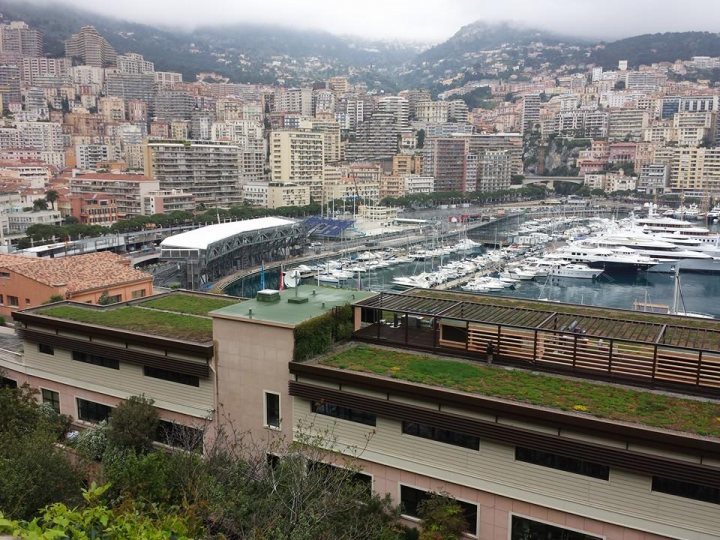 A train traveling over a bridge over a river - Pistonheads - The image showcases a scenic view of a seaside city. A prominent feature is a cruise ship docked at a sunny day by the pier. The city appears to be bustling, with numerous tall buildings reaching into the cloudy sky. A network of streets and parking lots can be seen, and there's a fair amount of greenery as well, adding a touch of nature to the urban landscape. The image captures the contrast between the city's architecture and the natural beauty of the waterfront.