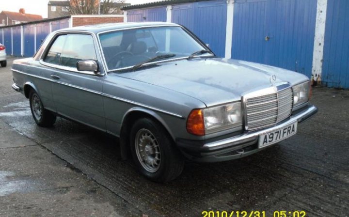 Pistonheads - The image shows a silver, vintage car parked on a concrete surface. The vehicle is a two-door sedan with a vinyl top, and its body shows a mix of paint finishes. The grille, emblem, and badges on the car are intact, and the headlights and taillights are prominently visible. The setting appears to be an urban or semi-urban environment, with a fence and blue doors in the background. The image also displays a time stamp at the bottom left corner, indicating it was taken on December 31, 2010, at 5:02 PM.