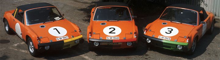 Orange Cars - Page 11 - General Gassing - PistonHeads - The image displays three small orange sports cars parked next to each other on a gravel lot. Each car carries a white number circle on the side, with the numbers 1, 2, and 3. The vehicles feature a classic, angular body style, with visible engine vents and air intakes on the hood. The cars are positioned with the front side facing the camera, showcasing the distinctive paint color and numbering. The setting is a simple, outdoor environment with no personal belongings or additional text visible.