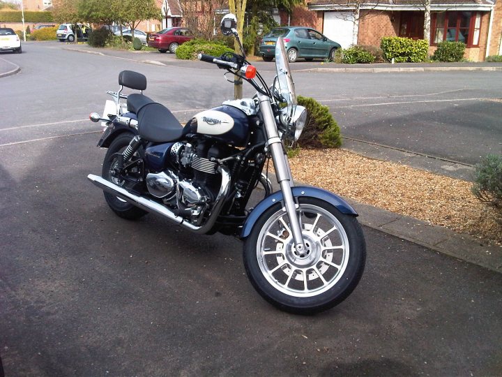 Post a picture of your bike thread 2011. - Page 33 - Biker Banter - PistonHeads - In the image, there is a motorcycle parked on the side of a street. The motorcycle is predominantly in shades of blue and black, giving it a sleek look. The motorcycle is parked on a driveway right in front of a house, suggesting that it belongs to someone living there. A car is parked in the background on the street next to the motorcycle. The driveway and street have a gray asphalt look, providing a neutral backdrop for the vivid colors of the motorcycle.