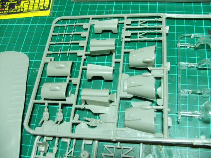 Pistonheads - The image shows a work area with a green preprinted cutting mat with several plastic parts scattered around. There is a prominent plastic saw that looks slightly used, indicating recent cutting activity. The plastic parts seem to be intricate and likely part of a model set, as they resemble the type of components that would be used in assembling a kit, possibly for a model car or airplane. The layout suggests an active workspace, possibly for someone engaged in building or customizing a model.