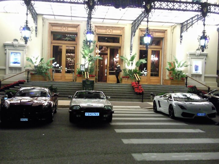 Pistonheads Jag Bit Wrong Xjs - The image captures a lively scene on a city sidewalk at night. There are three luxury sports cars parked along the sidewalk, each distinct in color and model, lending an air of elegance and prestige. Near the center of the image, a set of outdoor steps leads up to ornate wooden doors of a large, ornate building that serves as the backdrop. The front of the building is adorned with numerous potted plants, adding a touch of nature to the urban setting. Adding to the ambience, light fixtures cast a warm glow on the scene. A few individuals can be seen in the vicinity, mingling or possibly performing some tasks, adding a touch of life to this picturesque setting.