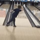 Little kid showing off his bowling skills