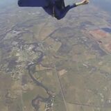 Skydiver saving a fellow skydiver having a seizure