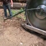 Farmer runs out of conventional ways to remove a difficult lug nut from a wheel uses a bulldozer attachment