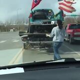 Women tearing down the confederate flag off a truck in South Dakota