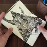 An artist showing off their sketchbook