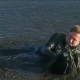 This guy swims through a river of mud to save a baby eagle.