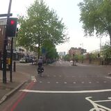 Cyclist jumps red light next to police car