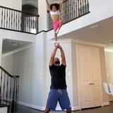 dad teaches his daughter cheerleader skills